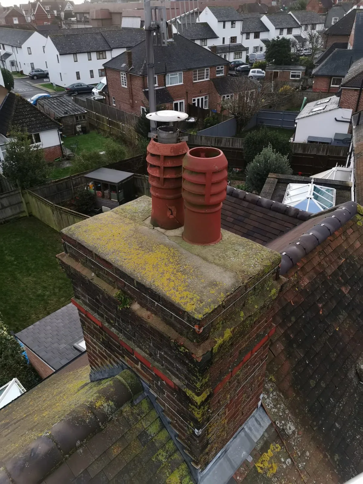 A chimney on top of a brick building.