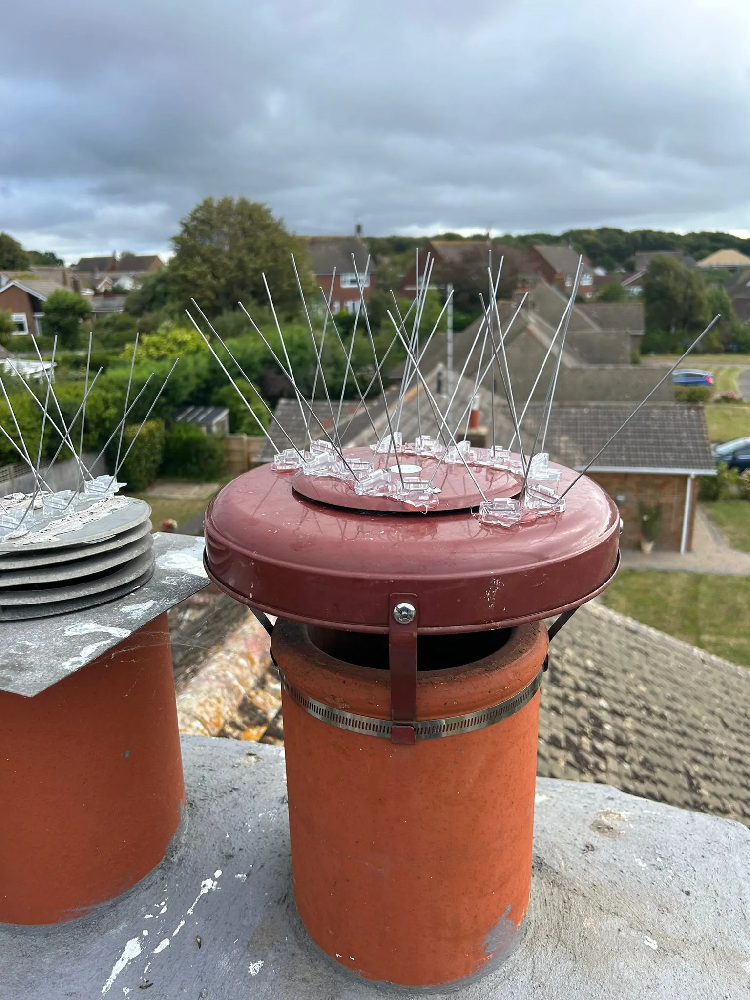 A couple of red containers sitting on top of a roof.