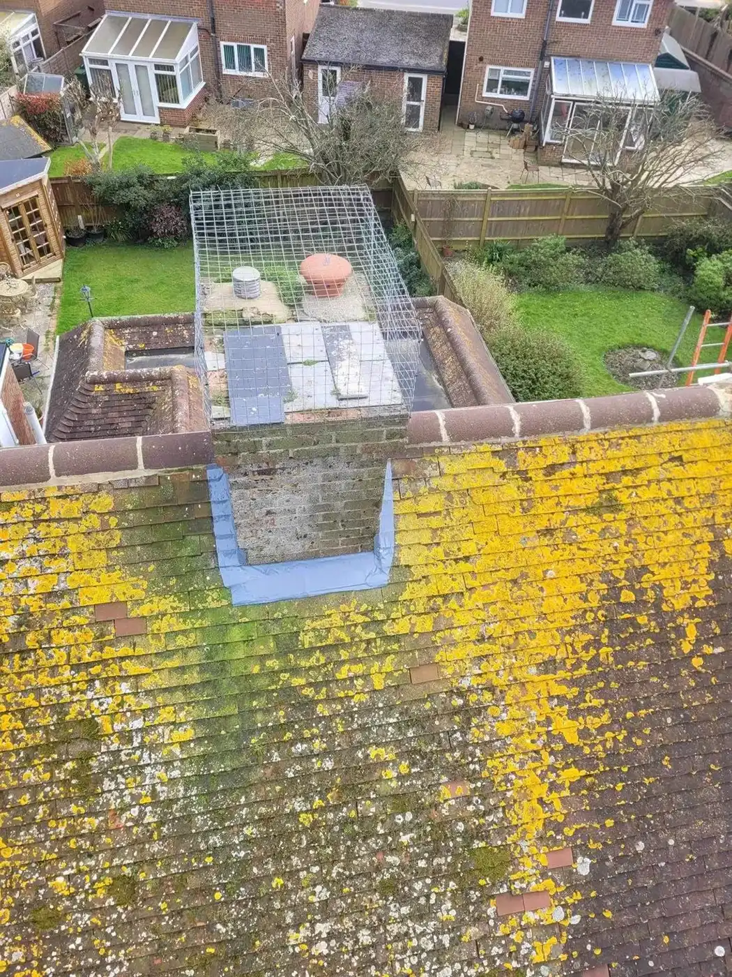 A roof with a bird cage on top of it.